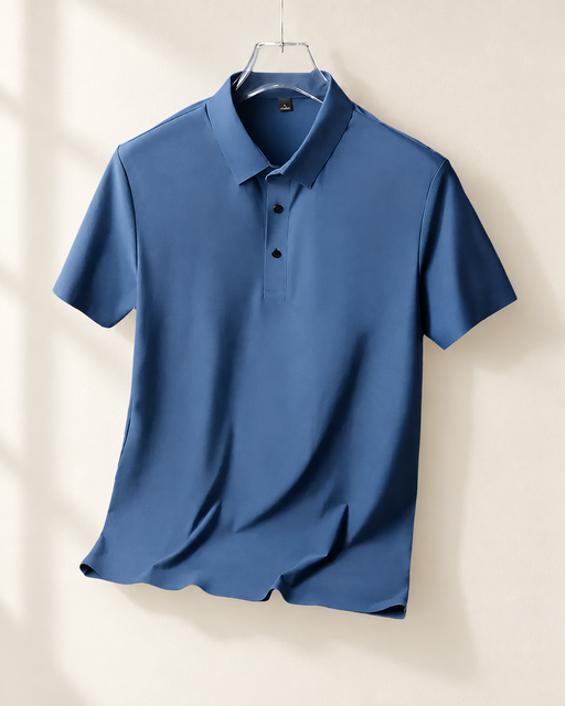 Haze blue polo shirt on a hanger against an ivory wall.