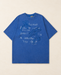 Blue oversized floral graphic T-shirt on an ivory surface.