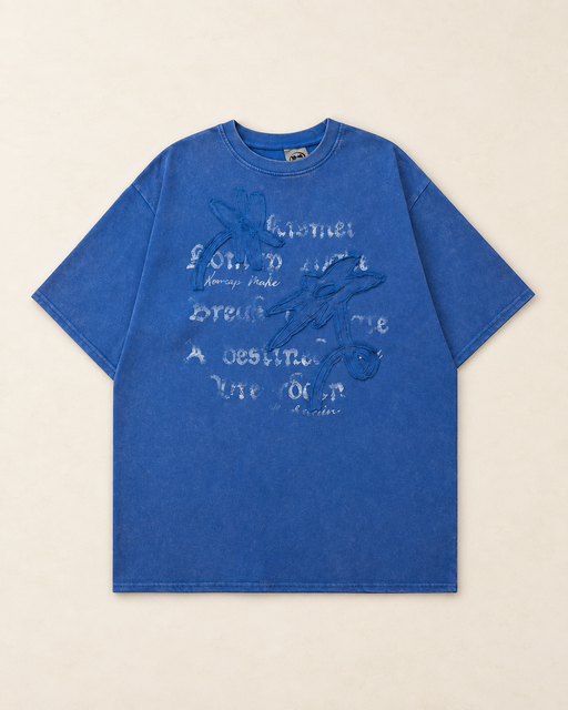 Blue oversized floral graphic T-shirt on an ivory surface.
