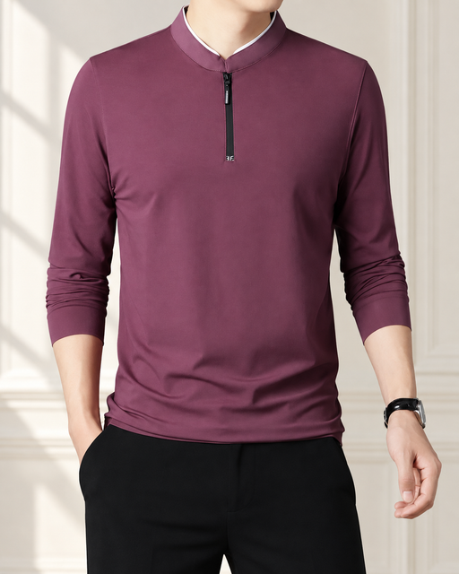 Burgundy stand-collar zip top worn by a male model in an ivory interior.