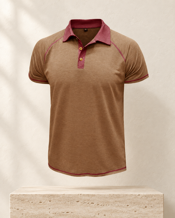 Brown short-sleeve polo with burgundy collar and contrast stitching against an ivory gallery wall.