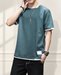 Green T-shirt with white layered trim in an ivory interior.