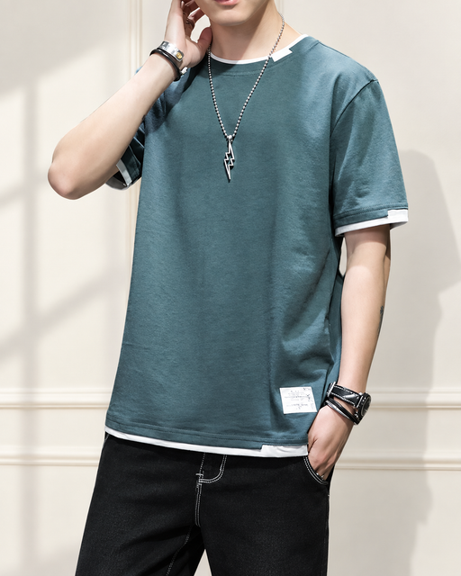 Green T-shirt with white layered trim in an ivory interior.