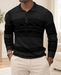 Black patterned long-sleeve polo in an ivory interior.