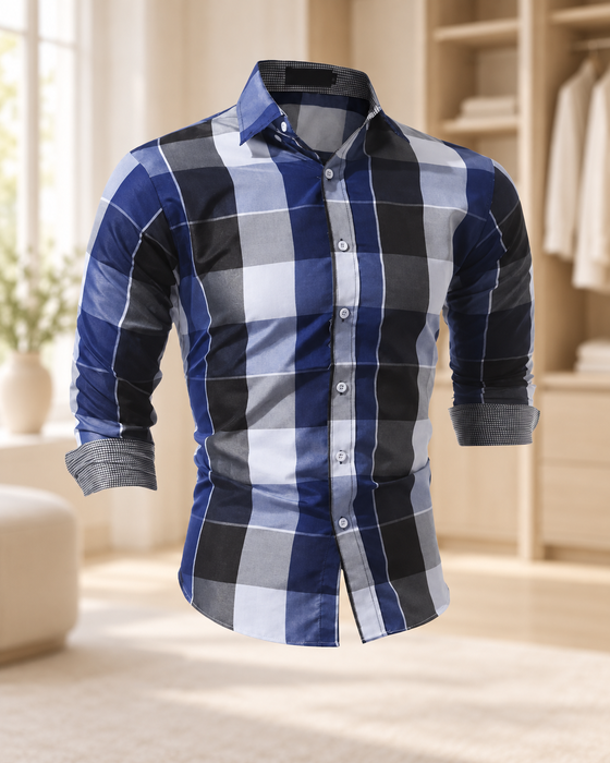 Blue, black and grey plaid shirt with rolled contrast cuffs displayed in a softly lit wardrobe interior.