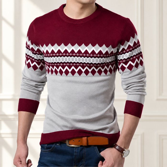 Burgundy and light-grey patterned sweater worn in a softly lit ivory interior