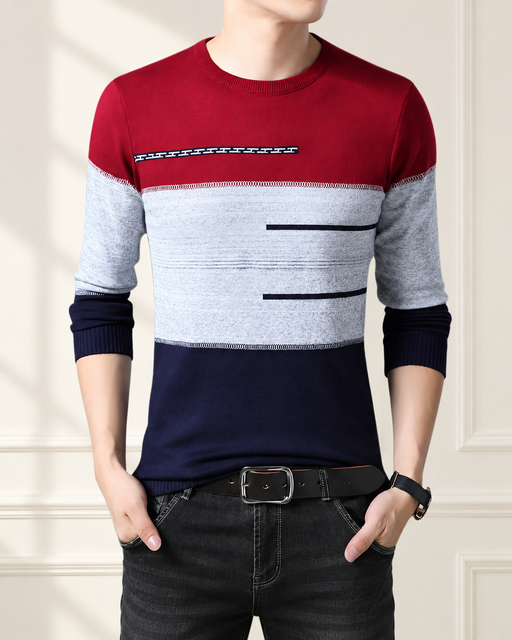 Red, grey and navy colour-block sweater in an ivory interior.