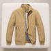 Khaki jacket with checked lining laid on an ivory upholstered bench