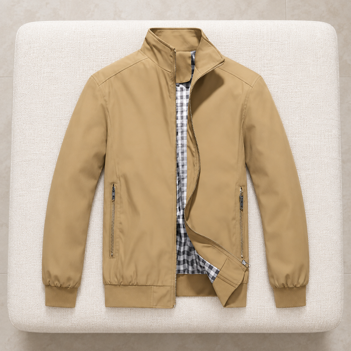 Khaki jacket with checked lining laid on an ivory upholstered bench