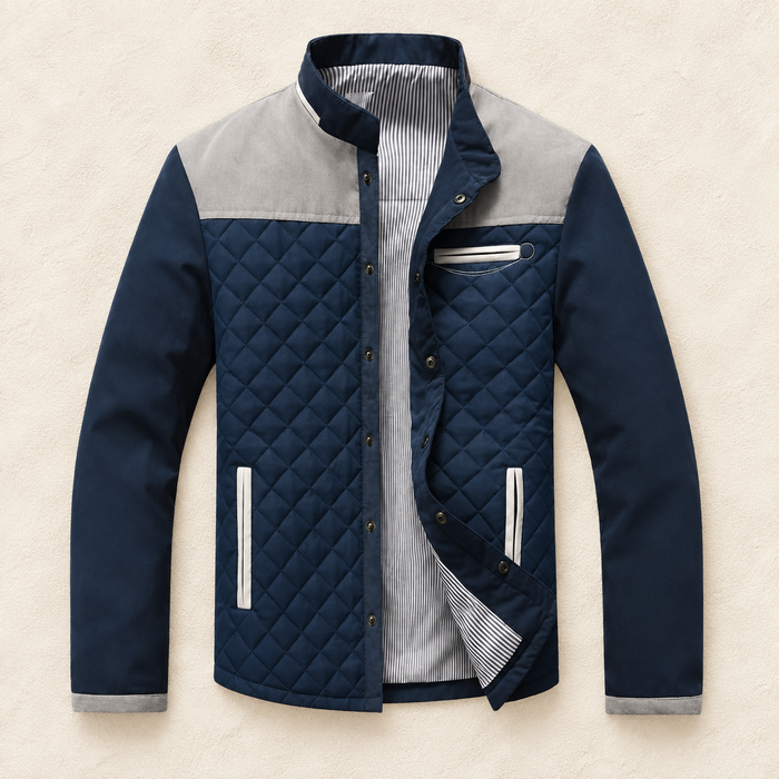 Navy quilted jacket with grey shoulder panels and pale pocket trims on ivory
