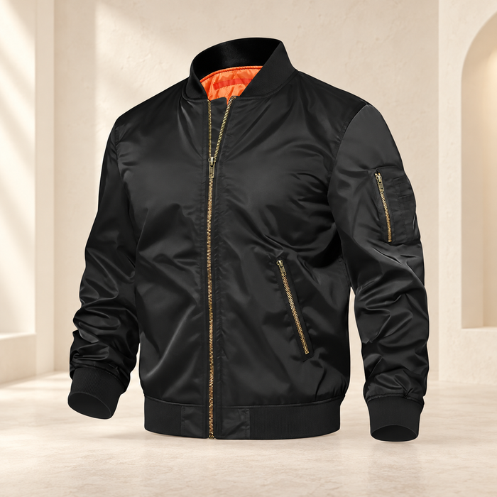Black bomber jacket with orange lining and brass zippers against an ivory backdrop.