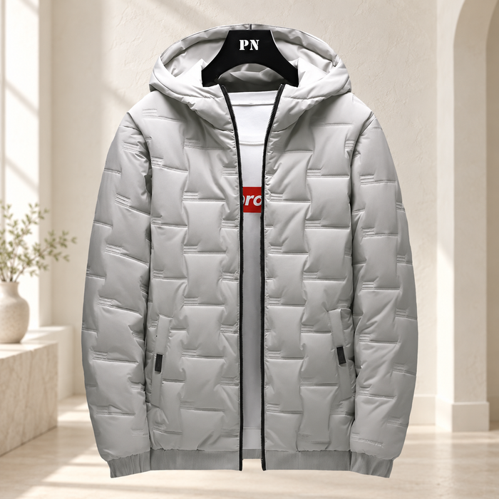 Grey quilted hooded jacket hanging against an ivory dressing-room backdrop.
