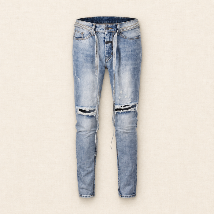 Light blue distressed jeans with long waist ties and two ripped knees on ivory linen