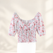 Pink floral crop top with gathered neckline and smocked waist