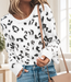 White leopard-pattern knit sweater worn in an ivory interior