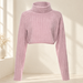 Pale pink cropped ribbed turtleneck sweater against a softly lit ivory dressing-room backdrop.