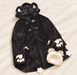 Black hooded coat with paw appliques and pink bows beside a small bear bag and pastel stars