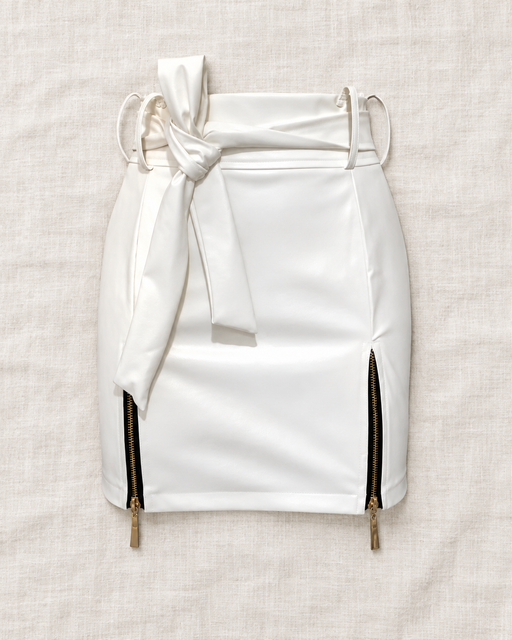 White mini skirt with a self-tie waist and two gold-tone side zippers on ivory linen.