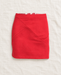 Red short skirt with diagonal front seams on ivory linen.