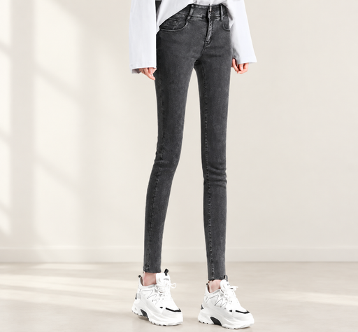 Charcoal skinny jeans with white sneakers in an ivory interior