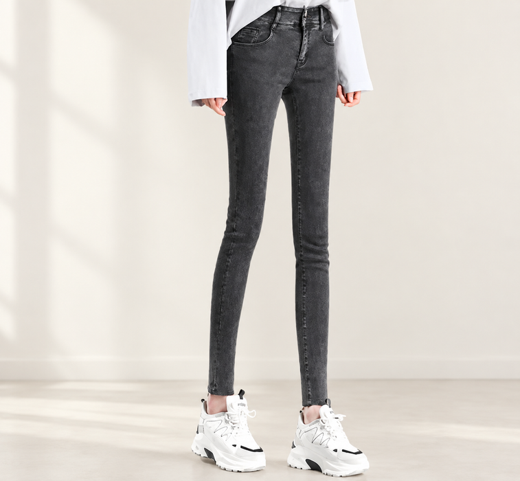 Charcoal skinny jeans with white sneakers in an ivory interior