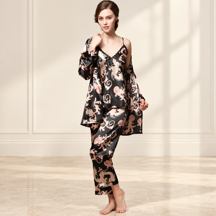 Woman wearing black and blush printed three-piece sleepwear in ivory interior.