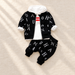 Black letter-print jacket and trousers with a white hooded top on ivory linen