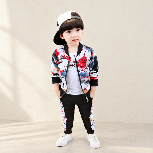 Printed jacket and black trousers with patterned side panels in an ivory studio
