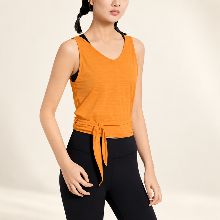 Orange sleeveless yoga top with side knot on model