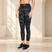Dark camouflage leggings in an ivory architectural setting