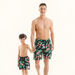 Matching floral swim shorts worn by parent and child