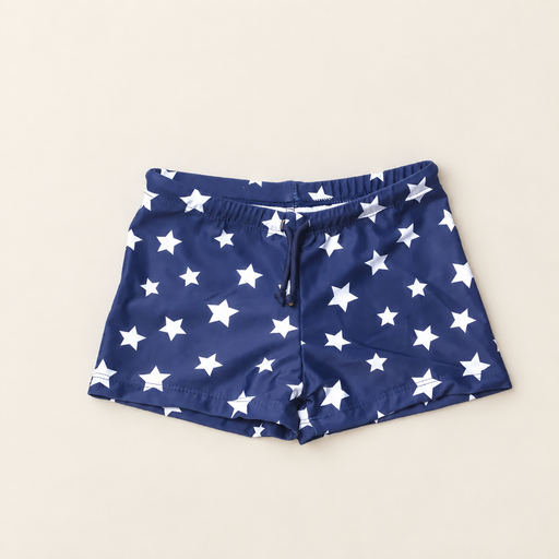 Navy shorts with white stars laid on an ivory surface.