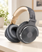 Grey and gold over-ear headphones on an ivory desk.