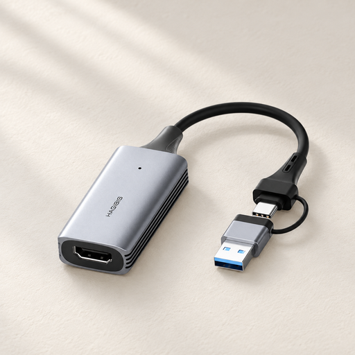 Silver video capture adapter with USB connectors on an ivory surface