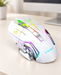 Pearl white T-WOLF gaming mouse with illuminated accents on an ivory desk.