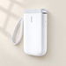White portable label printer with wrist strap on an ivory surface