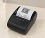 Black portable receipt printer on ivory countertop
