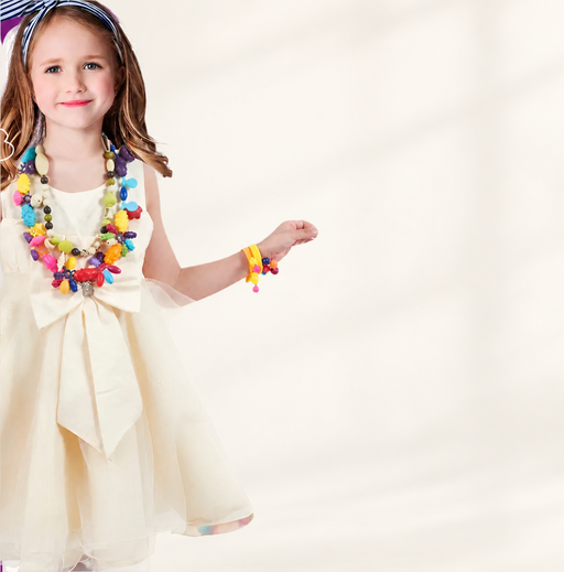 Child wearing colourful beaded necklaces and a bracelet against a warm ivory background.