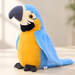 Blue and yellow plush parrot on an ivory tabletop