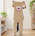 Unstuffed beige teddy bear casing held up in a bright craft room