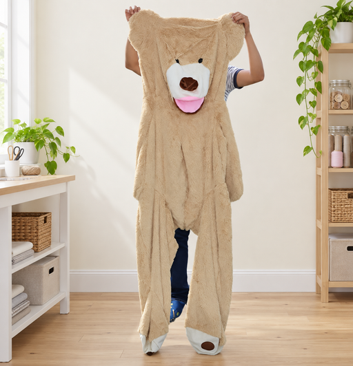 Unstuffed beige teddy bear casing held up in a bright craft room