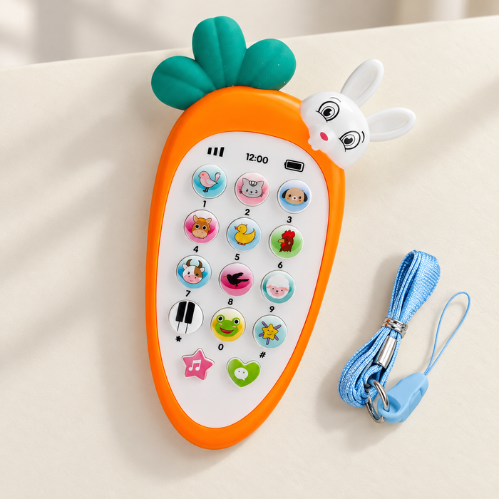Carrot-shaped toy phone and blue strap on an ivory surface
