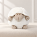 White sheep plush on an ivory upholstered bench