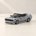 Grey construction-block racing car on an ivory table
