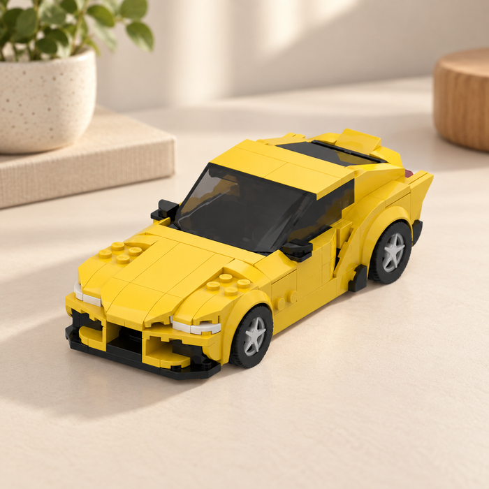 Yellow building-block sports car on ivory tabletop