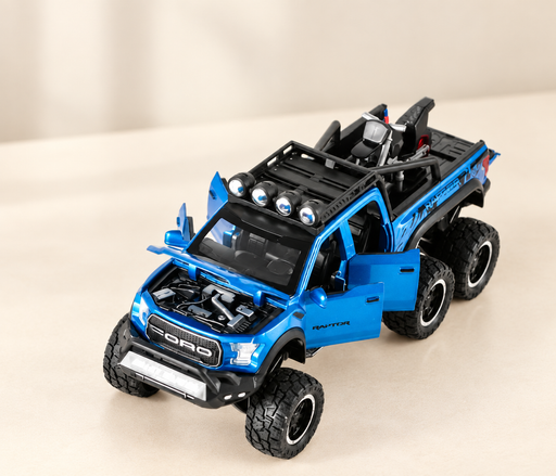Blue six-wheel toy pickup with open doors and hood, roof lights and motorcycle on an ivory surface