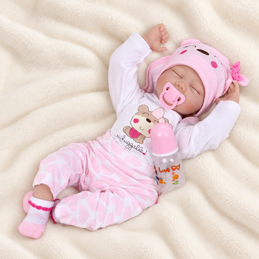 Sleeping toy doll in pink clothing with pacifier and bottle on ivory fabric.