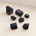 Seven black stone pieces on an ivory surface