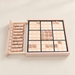 Wooden Sudoku board with numbered tiles and an open storage drawer