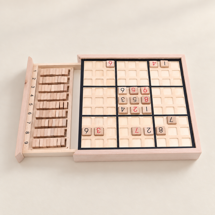 Wooden Sudoku board with numbered tiles and an open storage drawer
